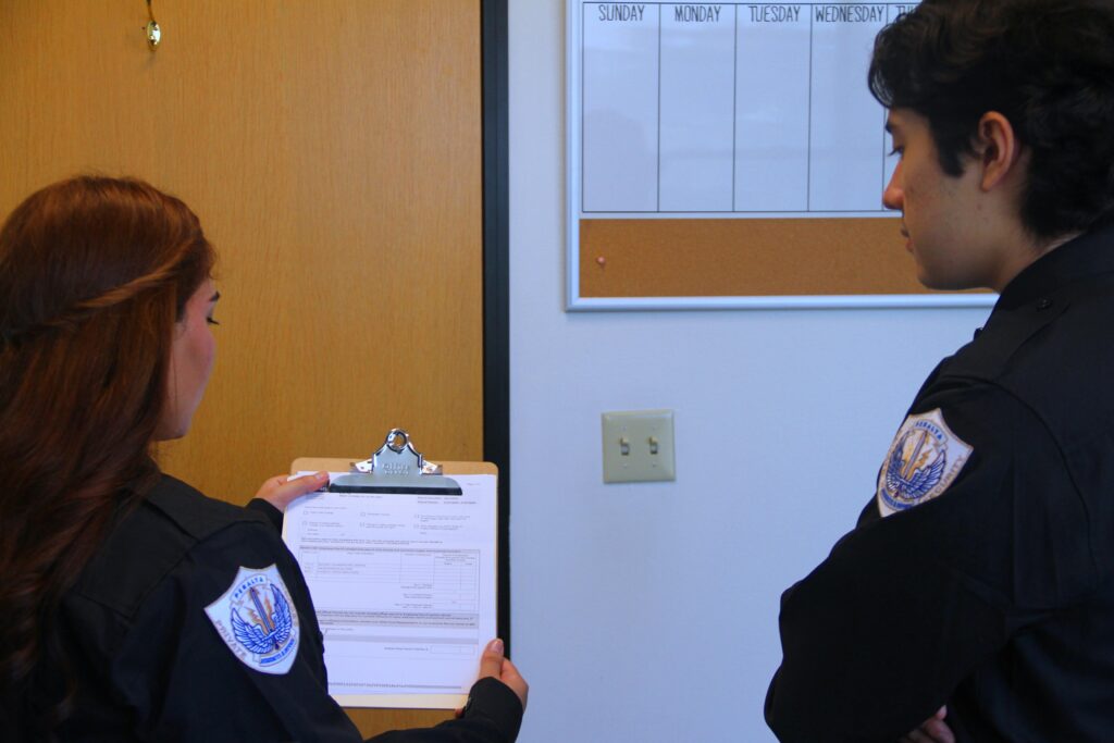 Two officers discussing national background checks