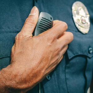 A person providing armed security services speaking on his radio