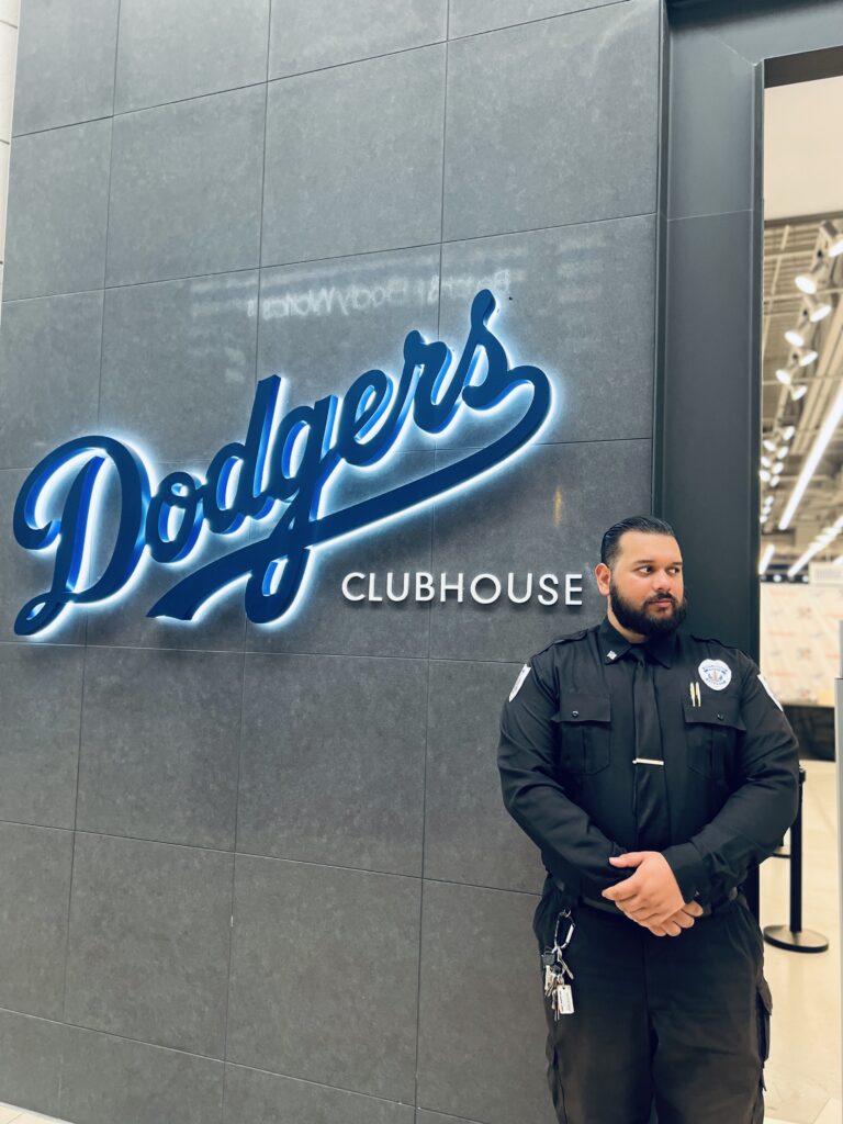 A security guard standing near the clubhouse of the L.A. Dodgers