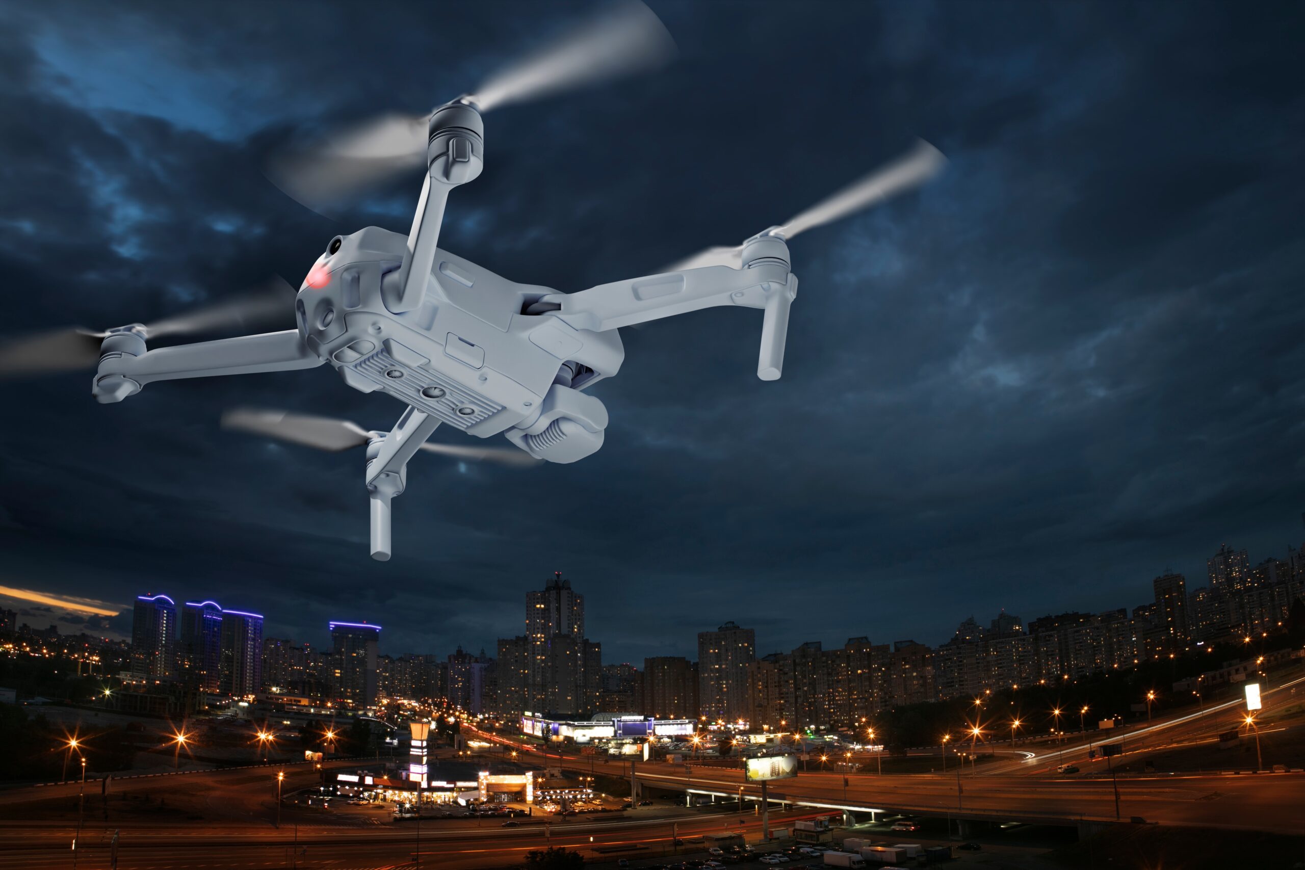 A drone flying over a city at night