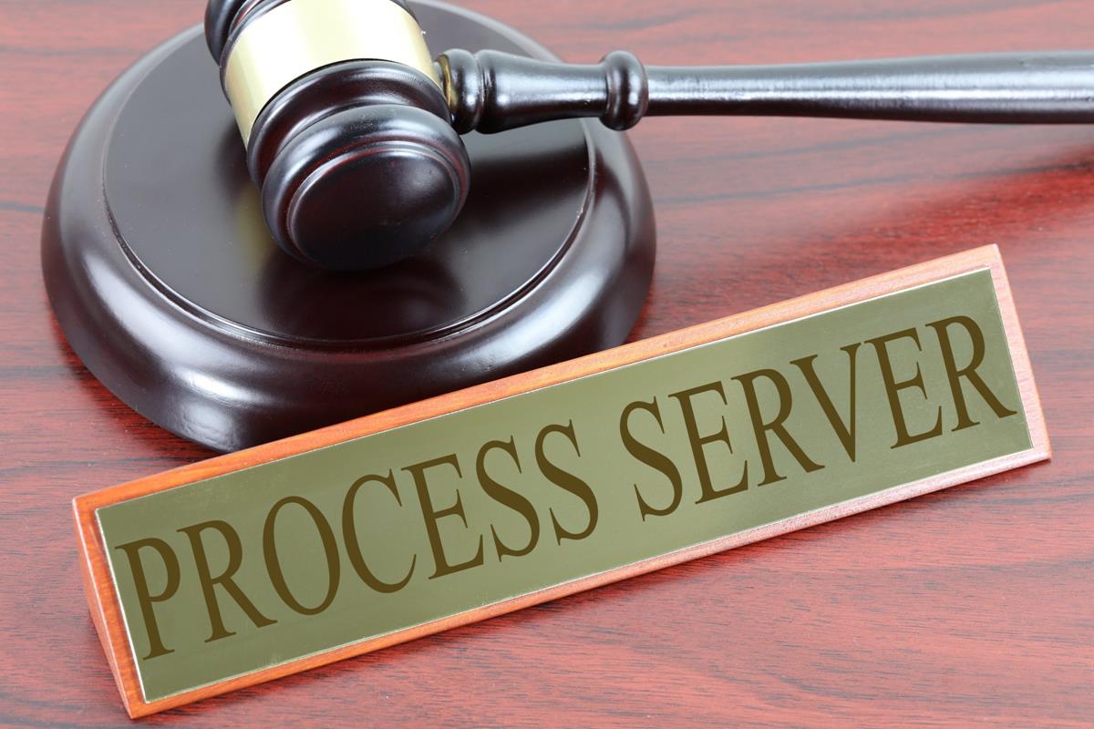 A nameplate that displays the words “process server”