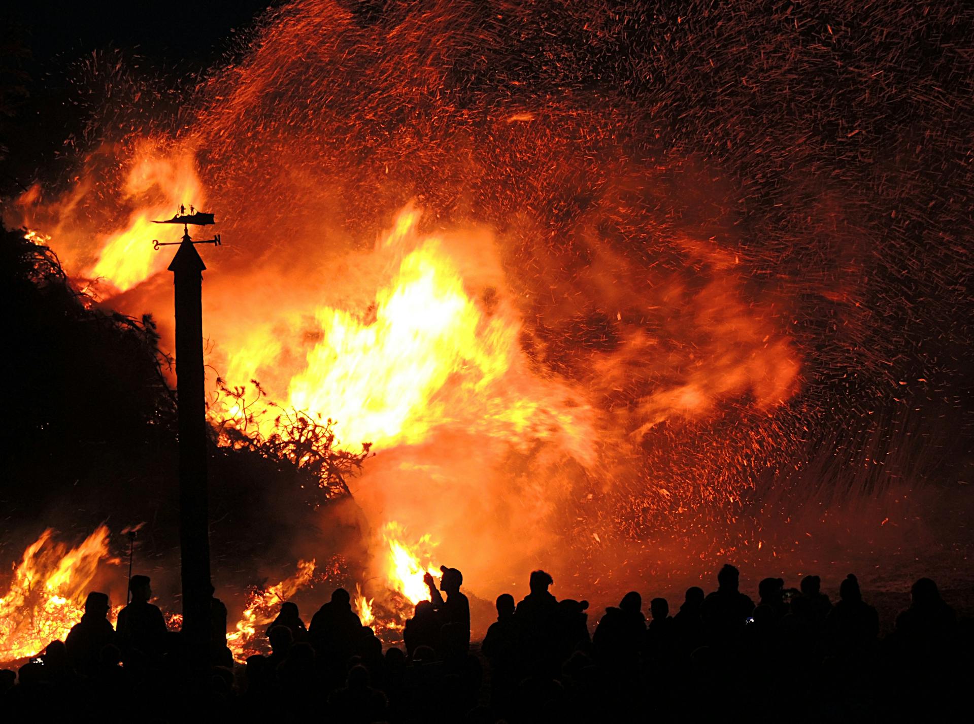 A fire watch service preparing to douse a large outdoor fire