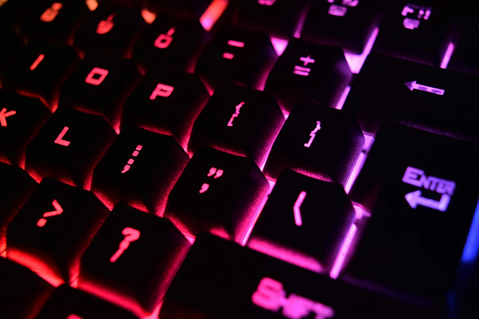 cyber-investigation-services A backlit mechanical keyboard, like one used by a person who provides cyber investigation services