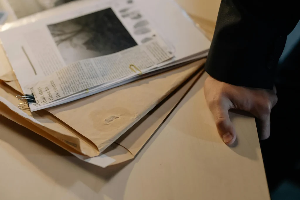 legal-private-investigator A legal private investigator standing next to a folder containing evidence